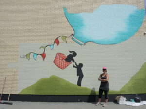 Une artiste crée une immense murale sur les murs de son ancienne école