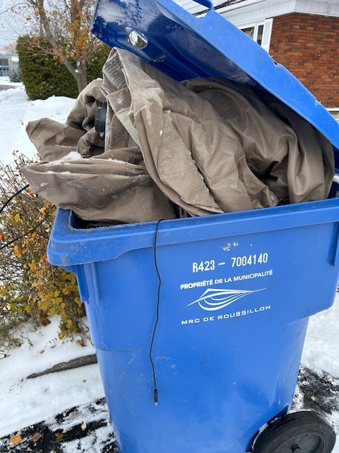 un matelas gonflable dans un bac de recyclage